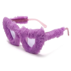 Detail of plush purple heart-shaped sunglasses with pink glitter transparent temples