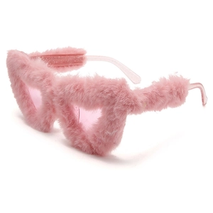Close-up of pink fluffy plush heart-shaped sunglasses with glittery temples for parties