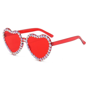 Detailed side view of red heart sunglasses with luxury rhinestones and crystal accents