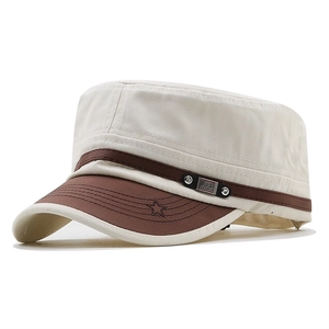 Flat top military cap in beige canvas with brown leather accents and metal emblem detail