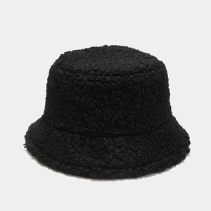 Close-up of soft black faux lamb wool texture on a warm winter bucket hat