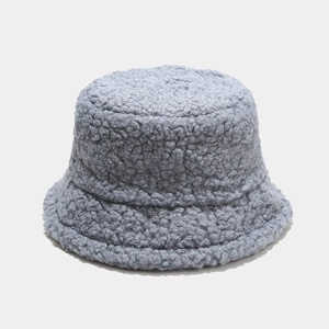 Close-up of soft light blue teddy fleece material on a winter bucket hat for women