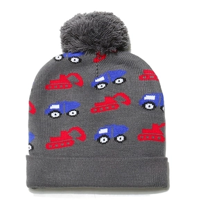 Detailed texture of kids knit beanie with excavator patterns and a soft pom-pom topper
