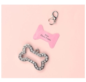 Macro shot of bone shaped pet id tag with silver rhinestones and pink photo frame insert
