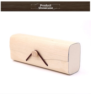 Detail of wooden bark eyeglass case featuring natural texture and button cord closure