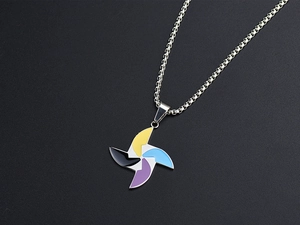 Detailed macro view of a colorful windmill pendant necklace with enamel fan blades