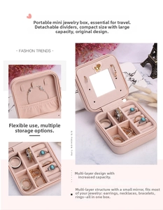 Detail view of pink mini jewelry box with mirror, earring hooks and removable dividers