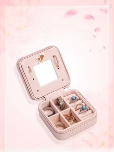 Pink portable jewelry box with interior vanity mirror and velvet multi-slot compartments