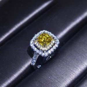 Macro shot of princess cut yellow moissanite ring with double halo pavé setting