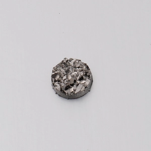 Detailed view of 6mm resin crystal cabochon with irregular glitter texture and metallic shine
