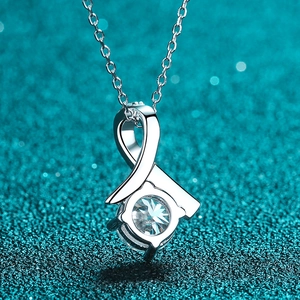 Polished S925 sterling silver necklace with a round sparkling pendant on blue glitter