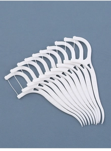 Detailed close-up of ultra-fine white dental floss picks arranged in a clean fan shape