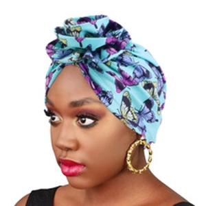Detailed view of African style turban with purple butterfly pattern in teal blue