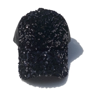 Detailed macro view of black sequins and breathable mesh panels on a baseball cap