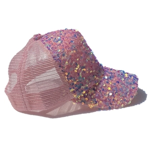 Side view of pink sequin trucker hat with breathable mesh back and sparkly visor detail