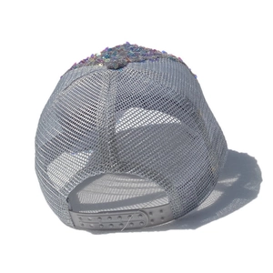 Detail view of the breathable mesh back and adjustable snapback closure on a sequined cap