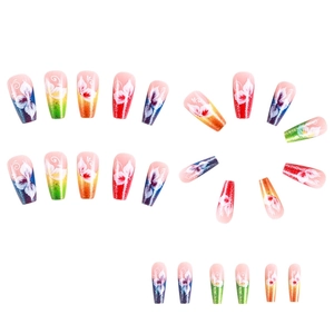 Long glitter press-on nails with gradient colors and white floral patterns