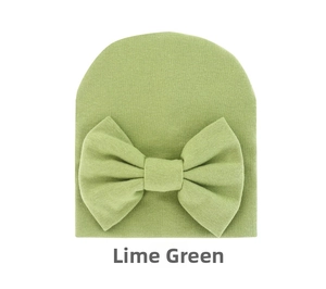Detail view of the soft fruit green knit baby hat featuring a large decorative bow