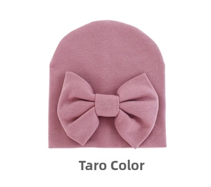 Detailed view of the soft taro purple knitted texture and large bow on this baby hat