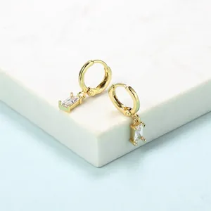 Minimalist gold-plated hoop earrings featuring a hanging rectangular zircon on marble stand