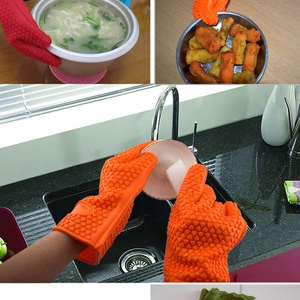 Orange heat-resistant silicone oven mitts with non-slip texture for cooking and cleaning