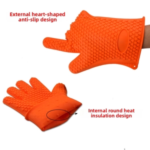 Detail of orange silicone oven mitts showing heart-shaped anti-slip and heat-insulating dots