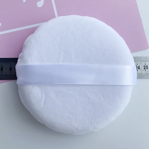 Macro shot of 9cm large white velvet powder puff showing texture and ribbon handle