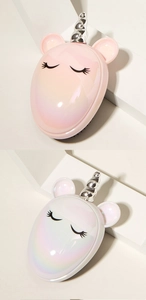 Close-up of pink and white unicorn massage hair brushes with shiny metallic horns