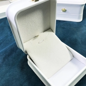 White PU leather jewelry box with gold crown detail for necklaces and pendants