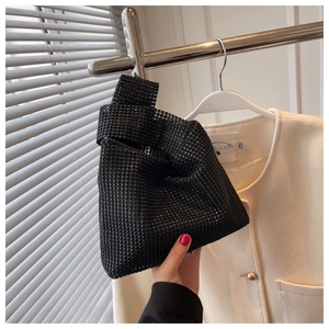Detailed view of the sparkling black rhinestone bucket bag with a single handle design
