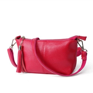Detail of rose red lychee grain leather purse with matching tassel and metal zipper