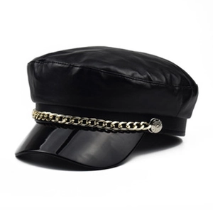 Detail of black PU leather newsboy hat featuring decorative gold chain and glossy brim