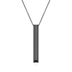 Detailed view of cylindrical whistle pendant in matte black finish on a fine chain