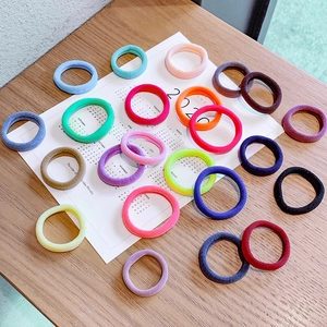 Colorful seamless elastic hair ties set made of soft high-stretch towel fabric on wood
