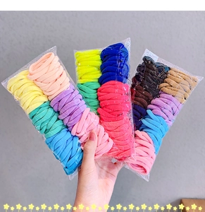 Detailed shot of multi-colored elastic hair ties set in transparent packaging bags