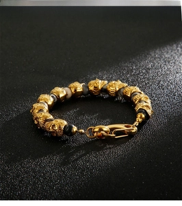 Close-up of gold skull beads with tiger eye stones and a heavy-duty lobster clasp