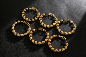 Detailed flat lay of skull bracelets featuring tiger eye and lava stone beads on a matte base