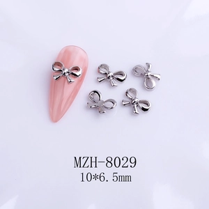 Silver bow nail charm with ribbon design and 10x6.5mm size detail for manicure art