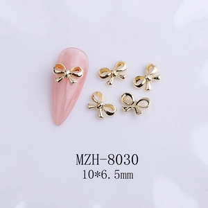 Macro shot of 3D golden ribbon bow nail charms with model MZH-8030 and size dimensions