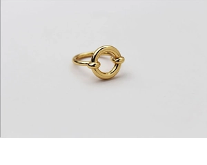 Detailed close-up of a 14k gold plated geometric circular ring with polished metal finish