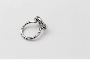 Macro detail of silver geometric double-loop brass ring on a clean white background