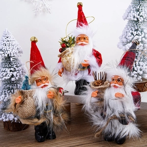 Three plush Santa Claus figures with textured hats and golden bells for holiday decor