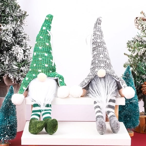 Christmas gnomes with green and grey knitted hats and long white beards on a snowy background