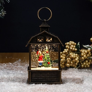 Detail of Christmas lantern with Santa, LED lights, and floating glitter in snow