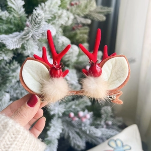 Cute Christmas reindeer antler hair clips with white ears and soft beige pompom details