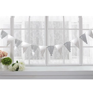 Detail of black and white wave pattern bunting banners hanging on a white window frame