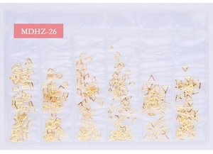 Close-up of golden geometric metal nail art studs in a six-compartment organizer case
