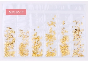 Detail of 6-grid nail art set with gold metal star, cross, and heart shaped studs