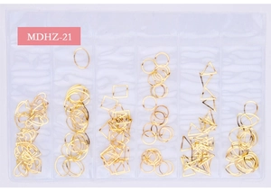 Close-up of golden hollow metal geometric shapes for DIY nail art in a 6-grid organizer