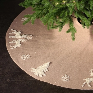 Knitted Christmas tree skirt featuring white reindeer and snowflake motifs in beige